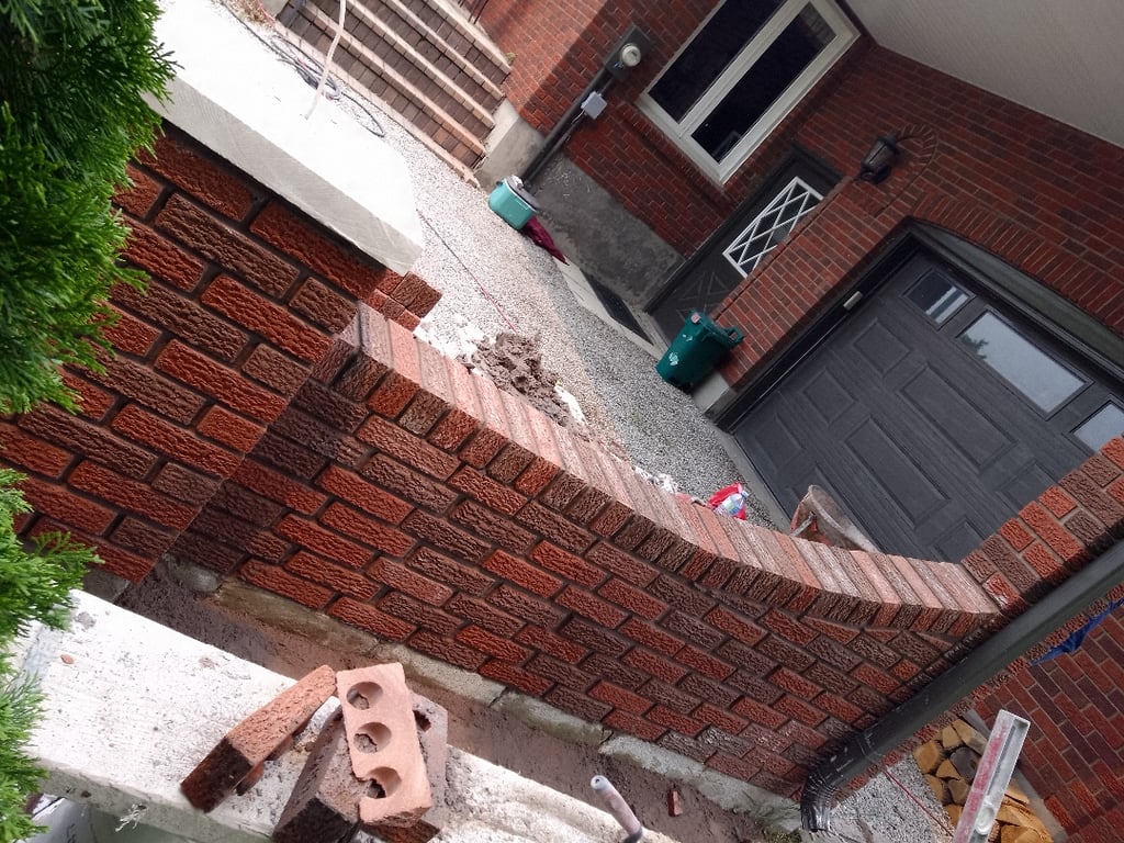 Custom masonry fireplace and stone feature wall designed for a Hamilton home