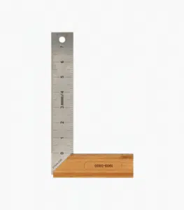 This image shows a metal ruler or measuring tool The ruler has markings and numbers indicating measurements likely in inches or centimeters The ruler appears to be made of a metallic material and has a wooden base or handle attached to it