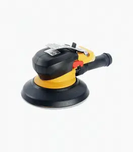 This image shows a black and yellow random orbital sander The sander has a round sanding pad that is surrounded by a black housing It has a yellow grip handle on the side and a power switch on the top This tool is commonly used for sanding and smoothing surfaces in various woodworking and construction projects