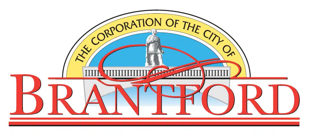 The image shows the official seal or logo of the City of Brantford The seal features a central image of a statue or monument likely representing a historical figure surrounded by a circular border with the text The Corporation of the City of Brantford written around it The logo uses a combination of red yellow and blue colors creating a bold and visually striking design