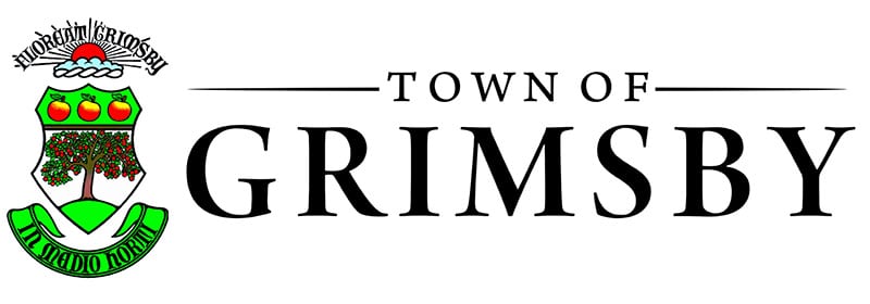 The image shows the town crest or logo for the Town of Grimsby The crest features a shield-shaped design with a tree in the center surrounded by three green circles or orbs The text TOWN OF GRIMSBY is prominently displayed below the crest in a bold black font