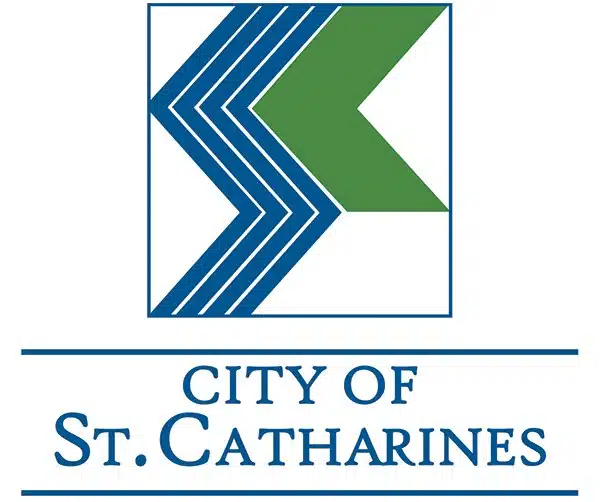 This image is the logo for the City of St Catharines The logo features a geometric design with blue and green triangles arranged in a chevron pattern The text CITY OF ST CATHARINES is displayed below the graphic design